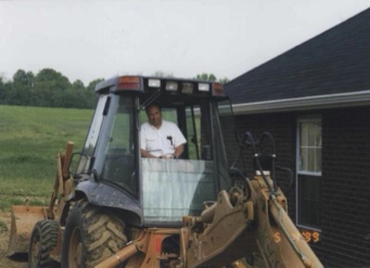 Brad Sterchi operating a backhoe at a residential construction site in 1999.